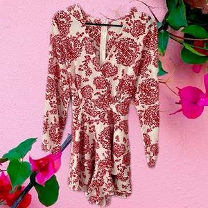 Red and white paisley romper. Long Flutter sleeves and tie in back.